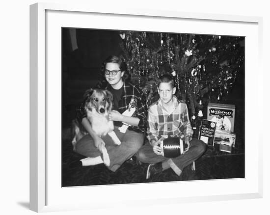 Brother and Sister Pose by the Christmas Tree, Ca. 1960-null-Framed Photographic Print