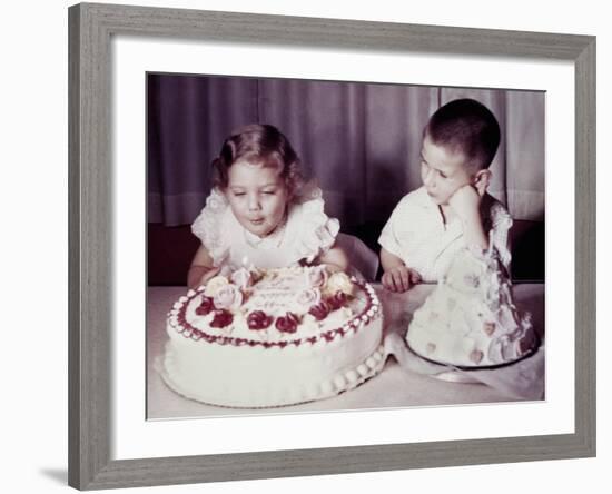 Brother Watches His Sister Blow Out Candles on Birthday Cake, Ca. 1956-null-Framed Photographic Print