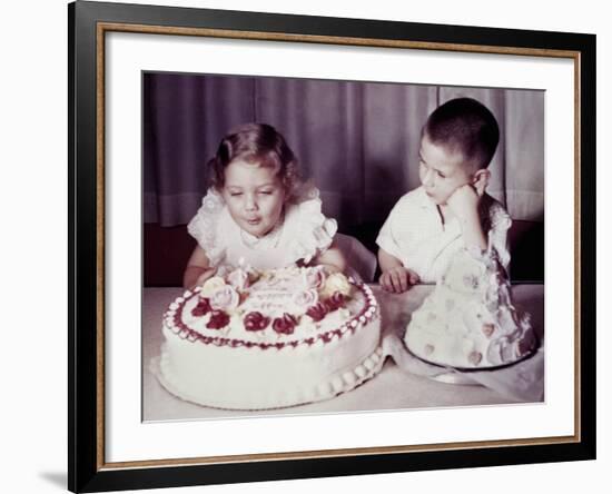 Brother Watches His Sister Blow Out Candles on Birthday Cake, Ca. 1956-null-Framed Photographic Print