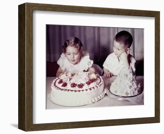 Brother Watches His Sister Blow Out Candles on Birthday Cake, Ca. 1956-null-Framed Photographic Print