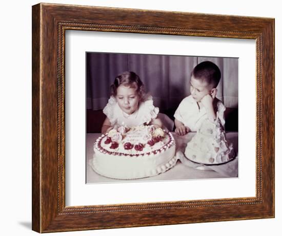 Brother Watches His Sister Blow Out Candles on Birthday Cake, Ca. 1956-null-Framed Photographic Print