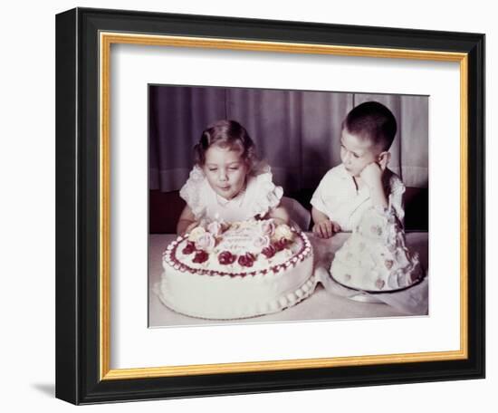 Brother Watches His Sister Blow Out Candles on Birthday Cake, Ca. 1956-null-Framed Photographic Print