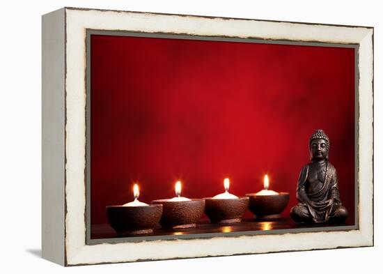 Buddha and Candles on Red Background, Religious Concept.-Sofiaworld-Framed Premier Image Canvas