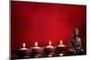 Buddha and Candles on Red Background, Religious Concept.-Sofiaworld-Mounted Photographic Print