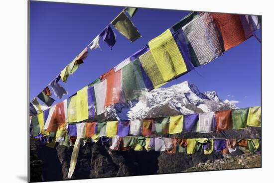 Buddhist Prayer Flags with Mount Kongde Ri Behind Taken Just Above the Town of Namche Bazaar-John Woodworth-Mounted Photographic Print