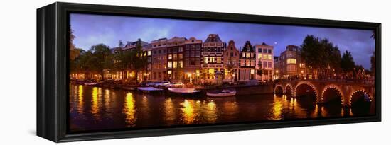 Buildings Along a Canal at Dusk, Amsterdam, Netherlands-null-Framed Stretched Canvas