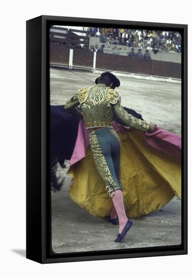 Bullfighter Manuel Benitez, Known as "El Cordobes," Sweeping His Cape Aside a Charging Bull-Loomis Dean-Framed Premier Image Canvas