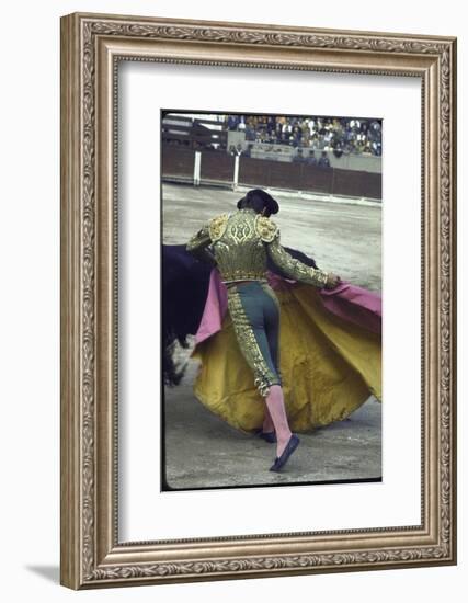 Bullfighter Manuel Benitez, Known as "El Cordobes," Sweeping His Cape Aside a Charging Bull-Loomis Dean-Framed Photographic Print