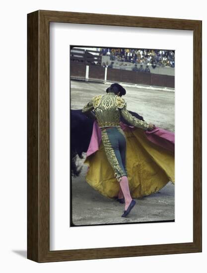 Bullfighter Manuel Benitez, Known as "El Cordobes," Sweeping His Cape Aside a Charging Bull-Loomis Dean-Framed Photographic Print