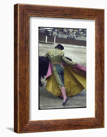 Bullfighter Manuel Benitez, Known as "El Cordobes," Sweeping His Cape Aside a Charging Bull-Loomis Dean-Framed Photographic Print