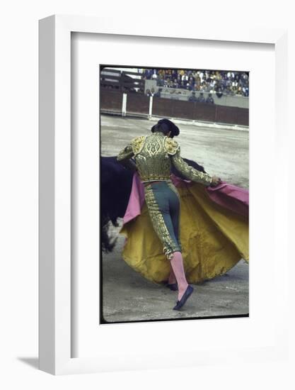 Bullfighter Manuel Benitez, Known as "El Cordobes," Sweeping His Cape Aside a Charging Bull-Loomis Dean-Framed Photographic Print