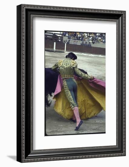 Bullfighter Manuel Benitez, Known as "El Cordobes," Sweeping His Cape Aside a Charging Bull-Loomis Dean-Framed Photographic Print