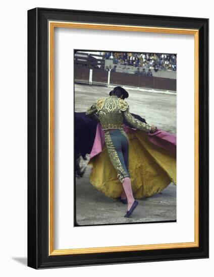 Bullfighter Manuel Benitez, Known as "El Cordobes," Sweeping His Cape Aside a Charging Bull-Loomis Dean-Framed Photographic Print