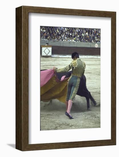 Bullfighter Manuel Benitez, Known as "El Cordobes," Sweeping His Cape Aside the Charging Bull-Loomis Dean-Framed Photographic Print
