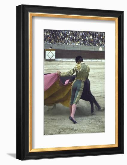 Bullfighter Manuel Benitez, Known as "El Cordobes," Sweeping His Cape Aside the Charging Bull-Loomis Dean-Framed Photographic Print