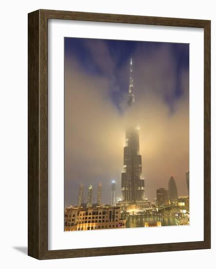 Burj Khalifa Illuminates the Clouds and Surrounding Skyline at Night, Downtown, Dubai, Uae-Amanda Hall-Framed Photographic Print