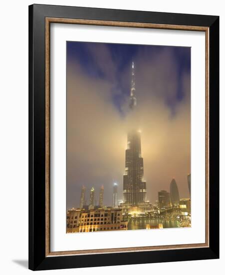 Burj Khalifa Illuminates the Clouds and Surrounding Skyline at Night, Downtown, Dubai, Uae-Amanda Hall-Framed Photographic Print