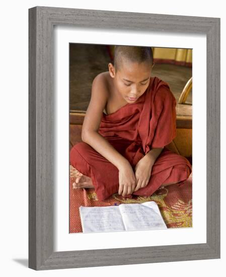 Burma, Lake Inle, A Young Novice Monk Learning at a Monastery School on Lake Inle, Myanmar-Nigel Pavitt-Framed Photographic Print