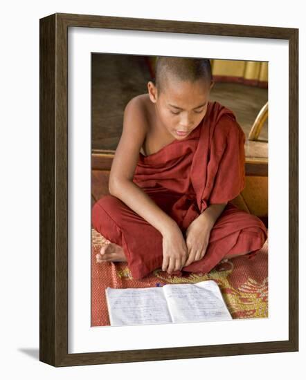 Burma, Lake Inle, A Young Novice Monk Learning at a Monastery School on Lake Inle, Myanmar-Nigel Pavitt-Framed Photographic Print