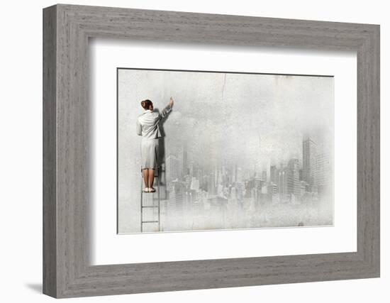 Businesswoman Standing on Ladder and Drawing Sketch on Wall-Sergey Nivens-Framed Photographic Print