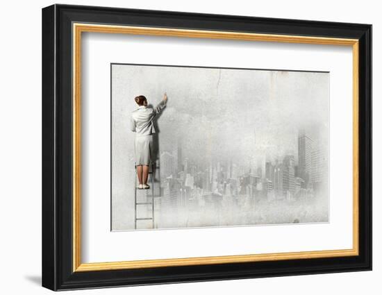 Businesswoman Standing on Ladder and Drawing Sketch on Wall-Sergey Nivens-Framed Photographic Print