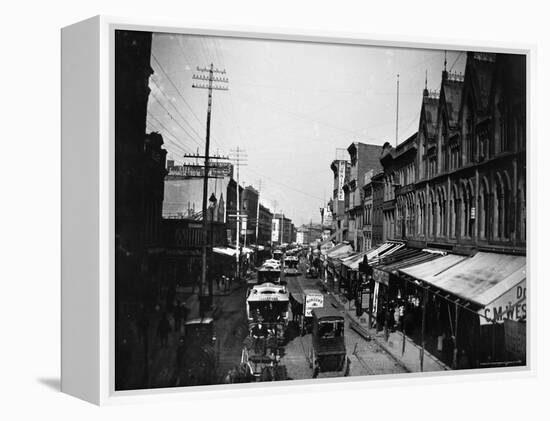 Bustling View of Fulton St, with Rows of Shops and Horse Drawn Carriages-Wallace G^ Levison-Framed Premier Image Canvas