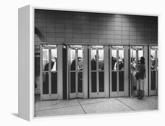 Busy Telephone Booths During an Airline Strike-Robert W^ Kelley-Framed Premier Image Canvas