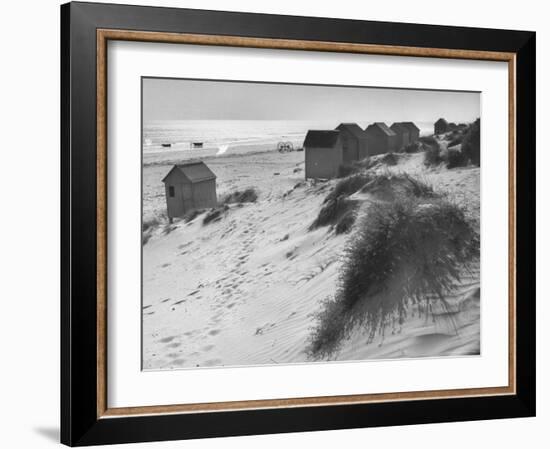 Cabanas Sitting on Sand Dunes with Clumps of Sea Grass Next to Rowboats-Eliot Elisofon-Framed Photographic Print