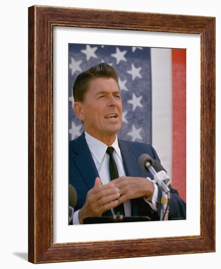 California Gubernatorial Candidate Ronald Reagan Speaking in Front of American Flag Backdrop-Bill Ray-Framed Photographic Print