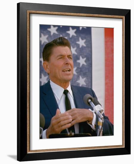 California Gubernatorial Candidate Ronald Reagan Speaking in Front of American Flag Backdrop-Bill Ray-Framed Photographic Print