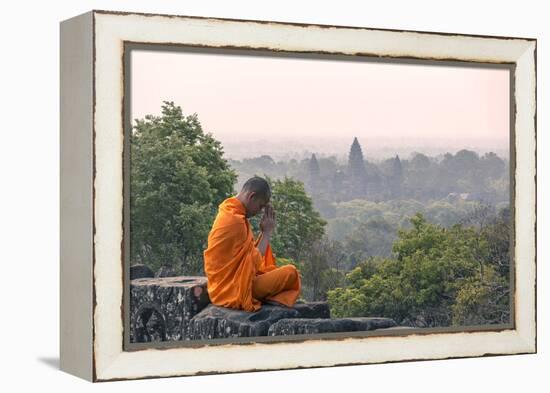 Cambodia, Siem Reap, Angkor Wat Complex. Monk Meditating with Angor Wat Temple in the Background-Matteo Colombo-Framed Premier Image Canvas