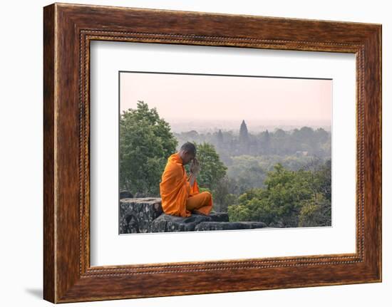 Cambodia, Siem Reap, Angkor Wat Complex. Monk Meditating with Angor Wat Temple in the Background-Matteo Colombo-Framed Photographic Print