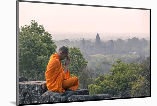 Cambodia, Siem Reap, Angkor Wat Complex. Monk Meditating with Angor Wat Temple in the Background-Matteo Colombo-Mounted Photographic Print