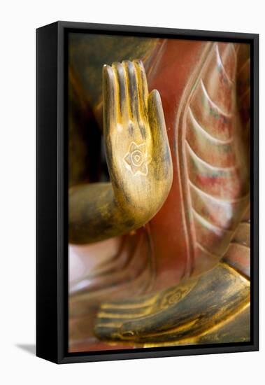 Cambodia, Siem Reap, golden hands on red wood statue of Buddha.-Merrill Images-Framed Premier Image Canvas