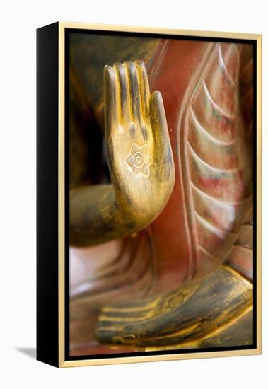 Cambodia, Siem Reap, golden hands on red wood statue of Buddha.-Merrill Images-Framed Premier Image Canvas