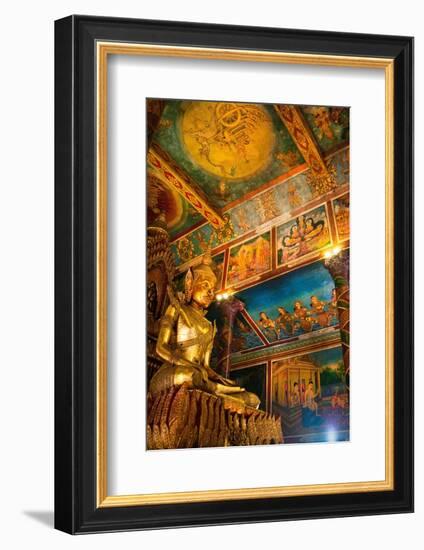Cambodia. Wat Phnom is the cities highest point in Phnom Penh. Statues inside the temple.-Micah Wright-Framed Photographic Print