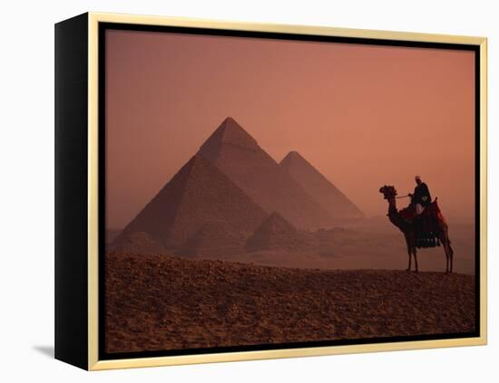 Camel and Rider at Giza Pyramids, UNESCO World Heritage Site, Giza, Cairo, Egypt-Howell Michael-Framed Premier Image Canvas