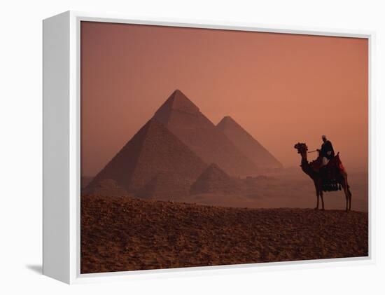 Camel and Rider at Giza Pyramids, UNESCO World Heritage Site, Giza, Cairo, Egypt-Howell Michael-Framed Premier Image Canvas