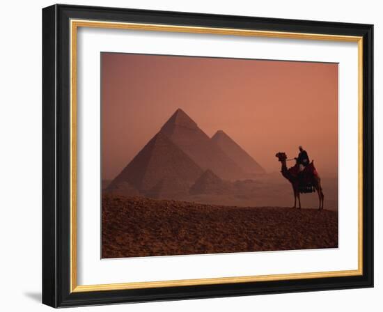 Camel and Rider at Giza Pyramids, UNESCO World Heritage Site, Giza, Cairo, Egypt-Howell Michael-Framed Photographic Print