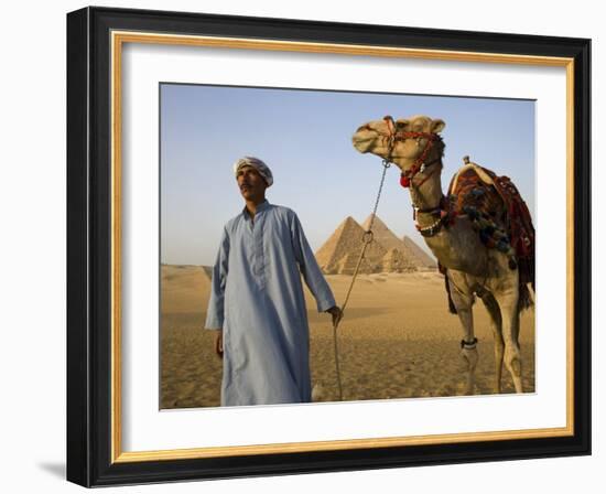 Camel Driver Stands in Front of the Pyramids at Giza, Egypt-Julian Love-Framed Photographic Print