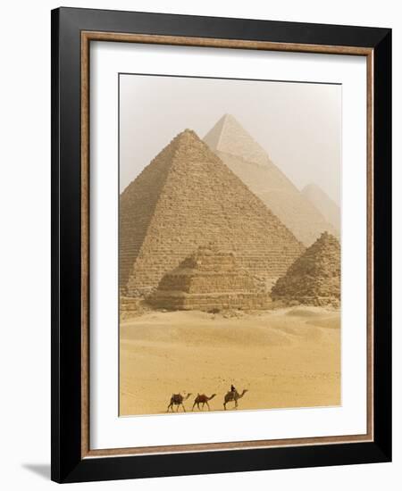 Camels Pass in Front of the Pyramids at Giza, Egypt-Julian Love-Framed Photographic Print