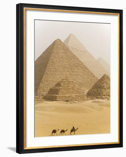 Camels Pass in Front of the Pyramids at Giza, Egypt-Julian Love-Framed Photographic Print