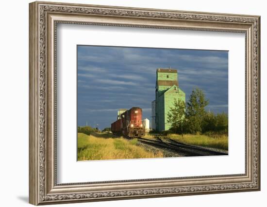 Canada, Alberta, Sexsmith. Grain elevators and train on railroad tracks.-Jaynes Gallery-Framed Photographic Print