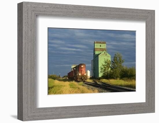 Canada, Alberta, Sexsmith. Grain elevators and train on railroad tracks.-Jaynes Gallery-Framed Photographic Print