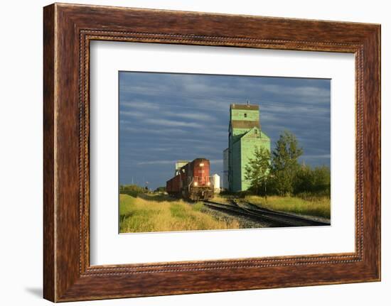 Canada, Alberta, Sexsmith. Grain elevators and train on railroad tracks.-Jaynes Gallery-Framed Photographic Print