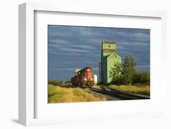 Canada, Alberta, Sexsmith. Grain elevators and train on railroad tracks.-Jaynes Gallery-Framed Photographic Print