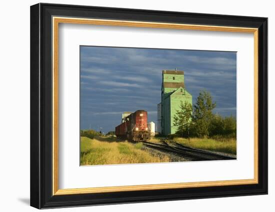 Canada, Alberta, Sexsmith. Grain elevators and train on railroad tracks.-Jaynes Gallery-Framed Photographic Print