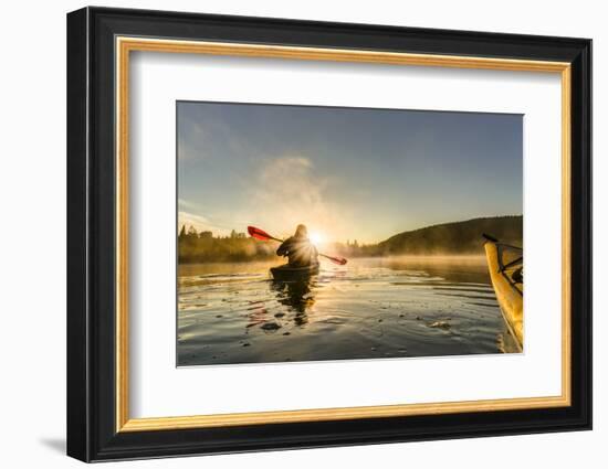 Canada, British Columbia. A kayaker paddles in morning mist on a Canadian lake.-Gary Luhm-Framed Photographic Print