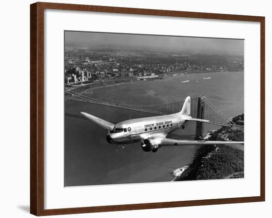 Canadian Colonial Airways Passenger Plane Flys over George Washington Bridge in Montreal, Canada-Margaret Bourke-White-Framed Premium Photographic Print