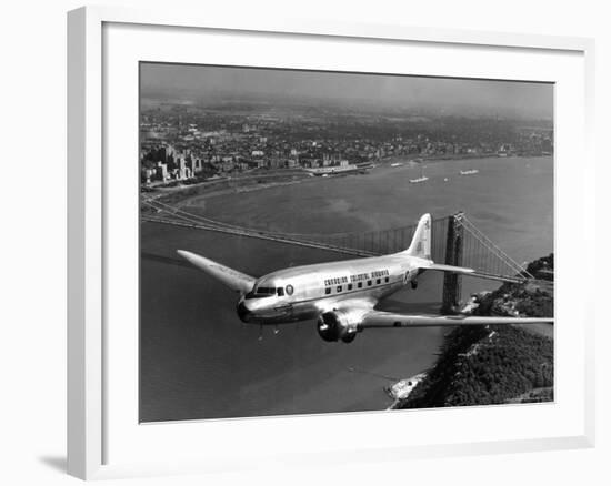 Canadian Colonial Airways Passenger Plane Flys over George Washington Bridge in Montreal, Canada-Margaret Bourke-White-Framed Premium Photographic Print